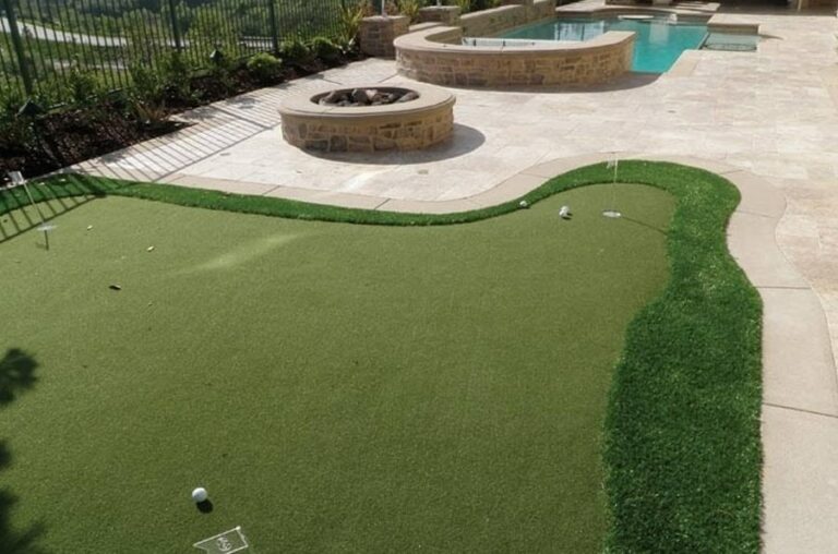 putting green with fire pit and paver patio