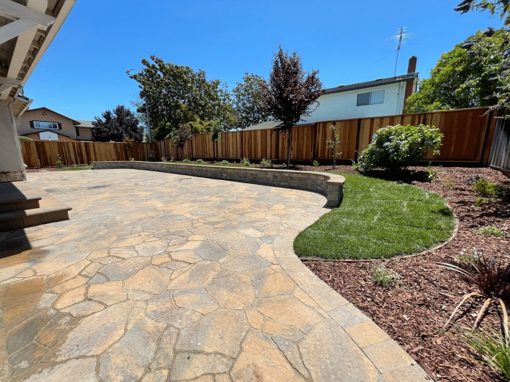 Large paver patio with seating wall and short retaining wall