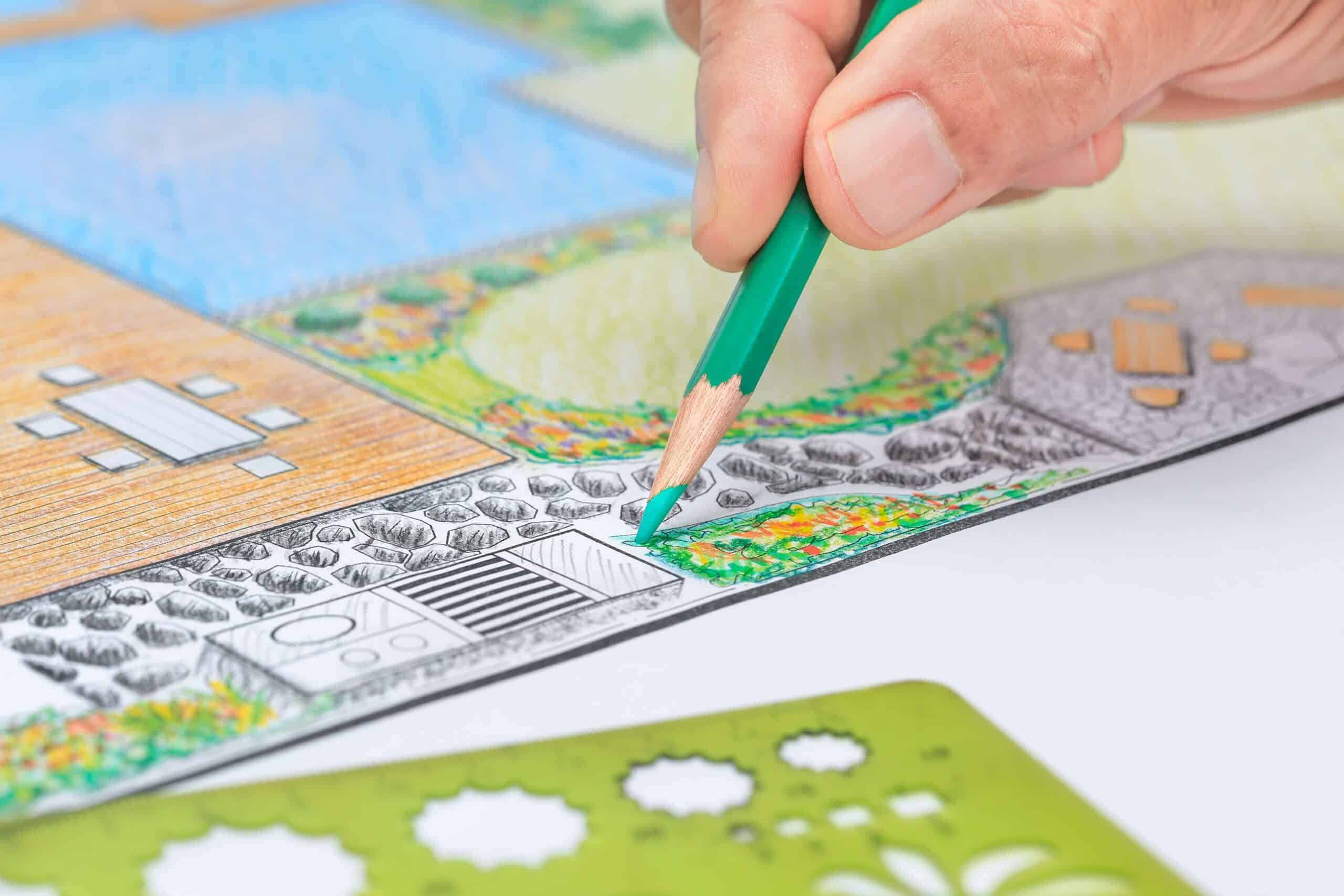 Landscape design contractor sketching a rendition of a landscaping concept.