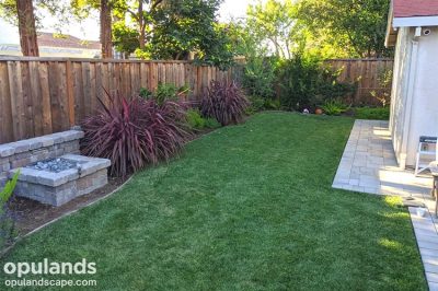 New backyard landscaping with fountain and lawn