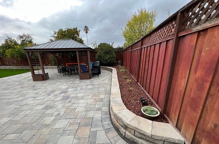 paver patio, pergola, short retaining wall by Opulands